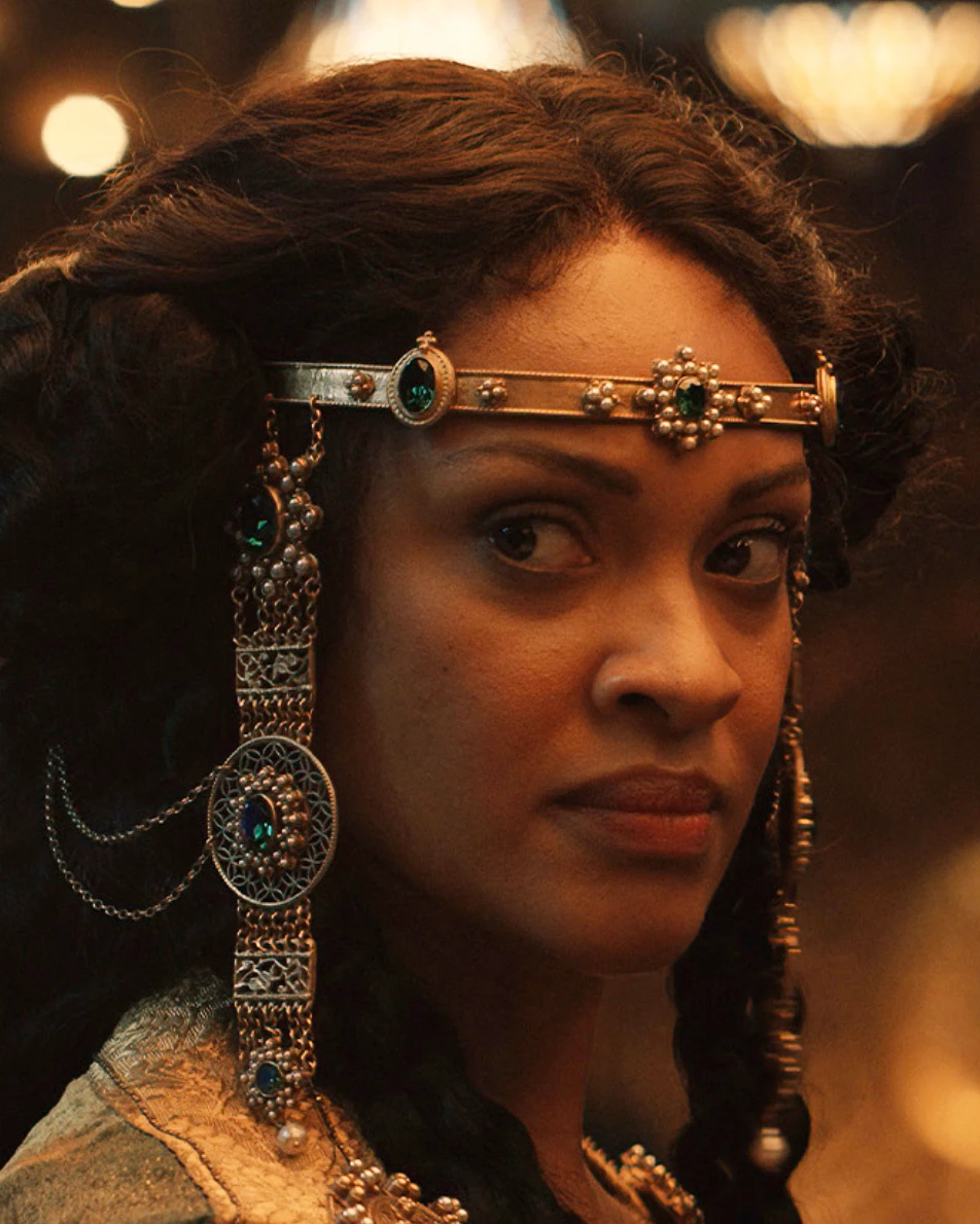 Film costume featuring a jewelled headband with circular ornaments and long hanging chains.